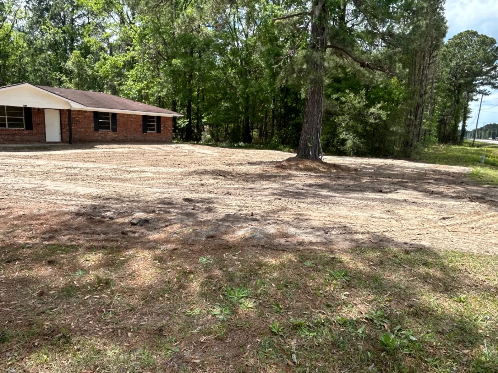 Finished land clearing and grading , ready for grass