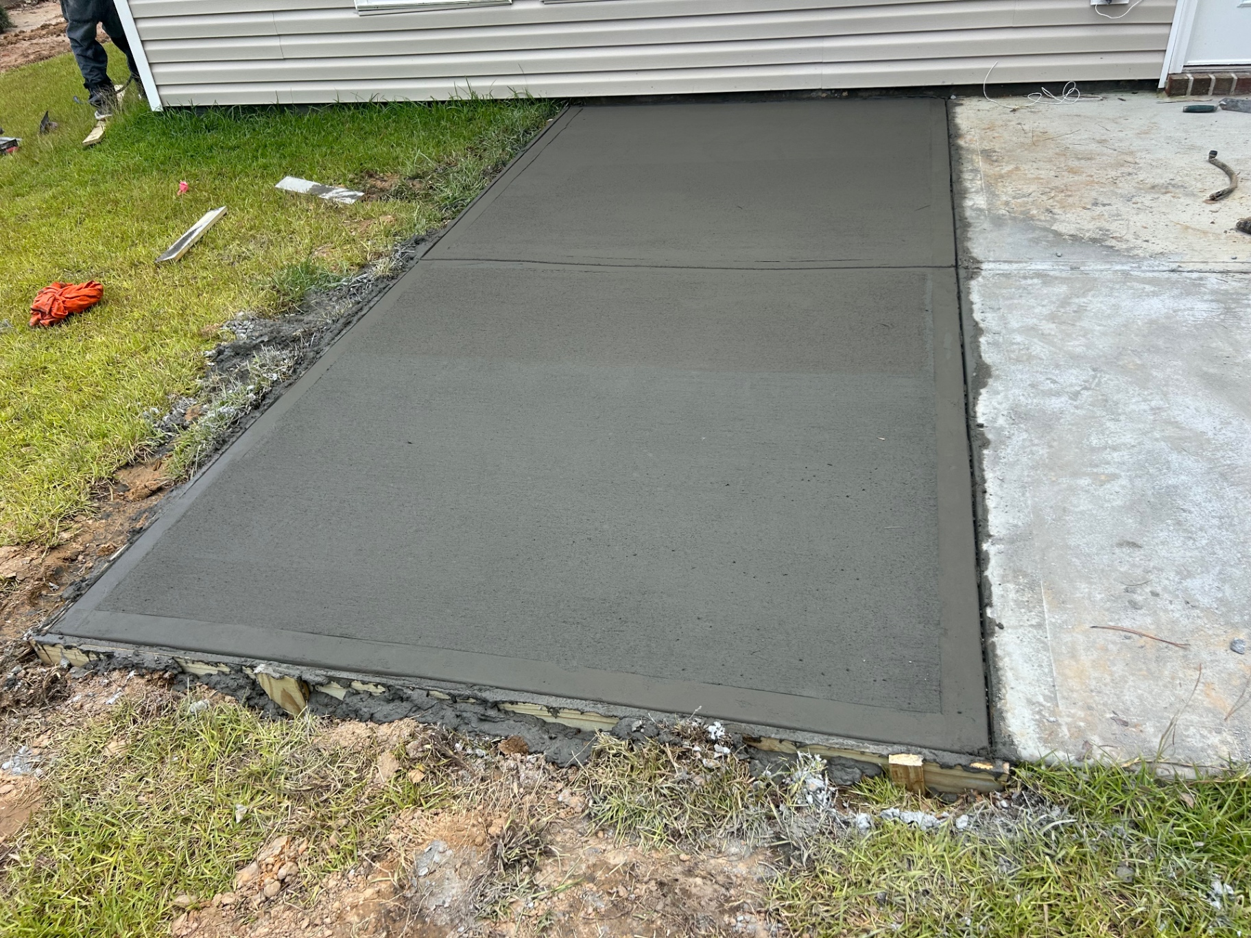 Fresh concrete pad poured and finished at a residence
