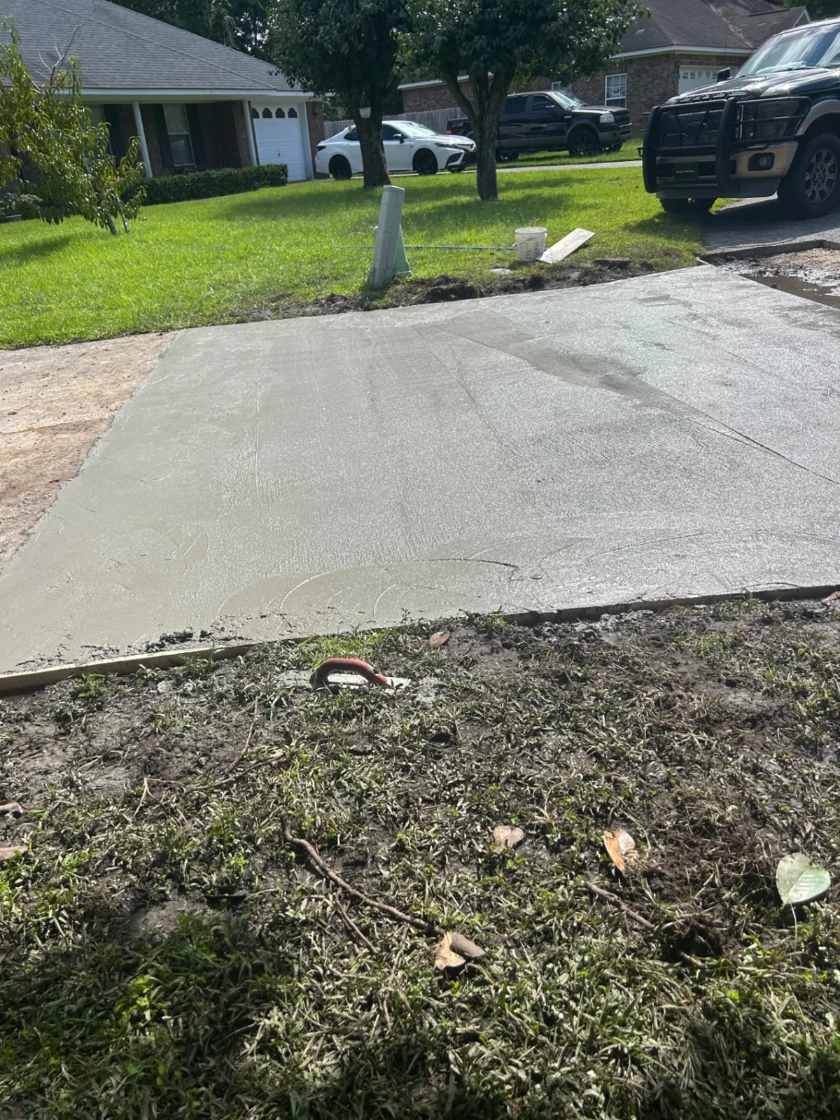 Broom-finished concrete driveway, ready to cure
