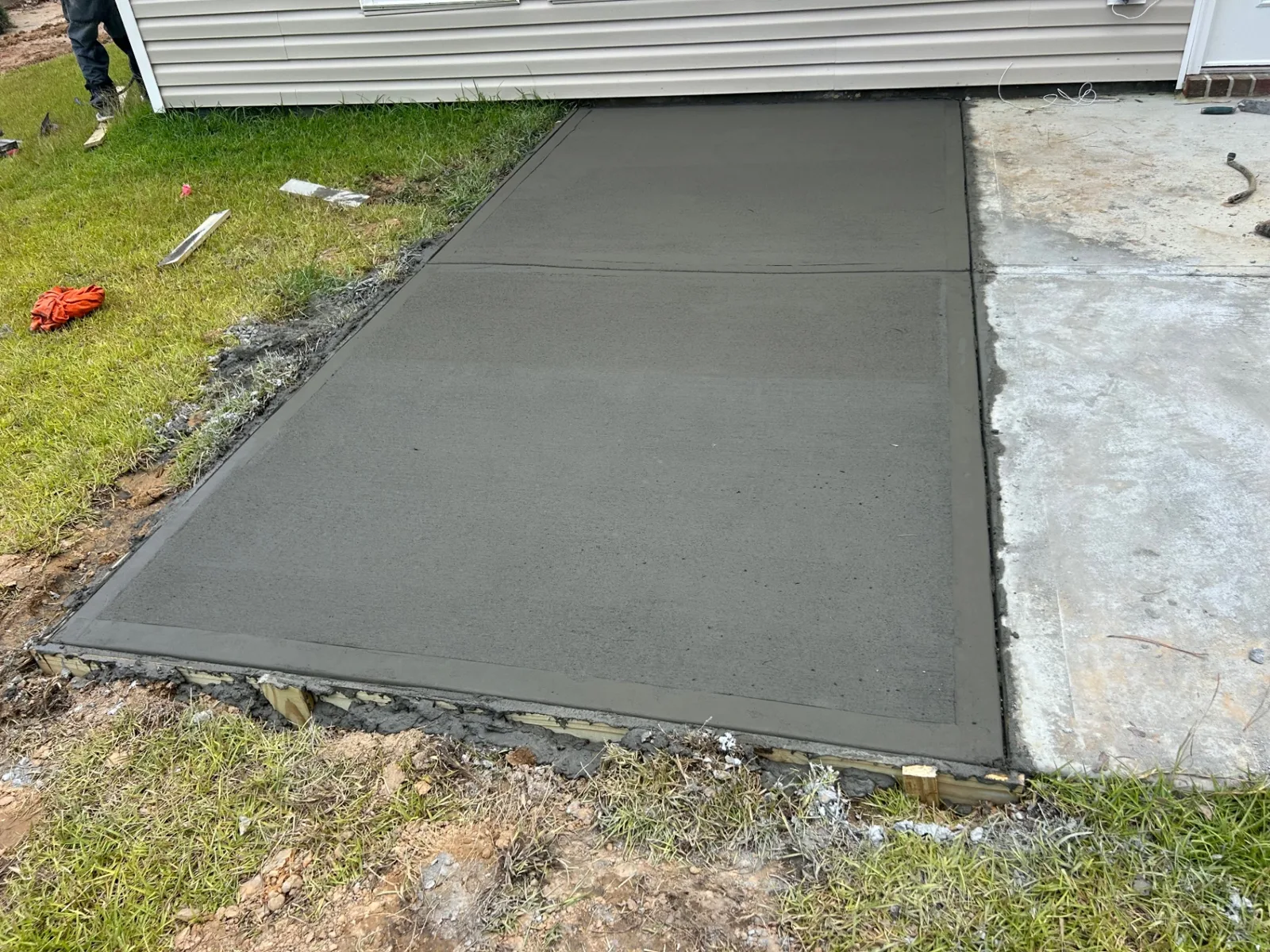 Fresh concrete pad poured and finished at a residence